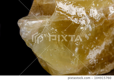 Macro mineral stone yellow Calcite on a black background Macro mineral stone yellow Calcite on a black background 104915760