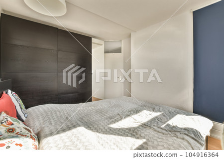 a bedroom with blue walls and white bed in the fore - image viatio com / photo viatio 104916364