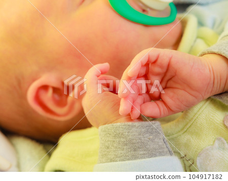 Closeup of little newborn sleeping with teat in mouth Closeup of little newborn sleeping with teat in mouth 104917182