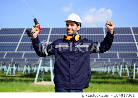 Engineer worker portrait with solar panel at solar farm 104917361