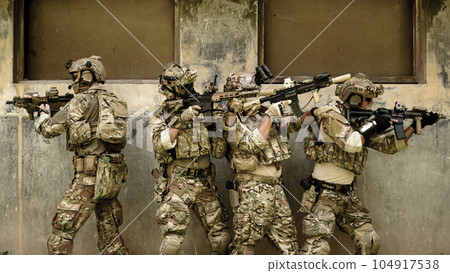 Squad of soldiers running forward and attacking enemy during military operation, Army soldiers in protective combat uniform, Soldiers with rifle in forest, Soldiers with rifle on world war field Squad of soldiers running forward and attacking enemy during military operation, Army soldiers in protective combat uniform, Soldiers with rifle in forest, Soldiers with rifle on world war field 104917538