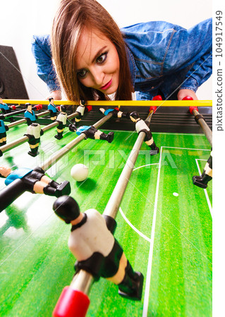 woman playing table football game 104917549