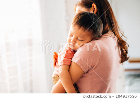 Happy mother and hugging embracing little son with love and care 104917550