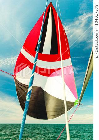 Spinnaker with uphaul, blue sky in background. 104917578