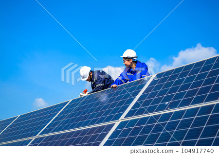 Solar panel station, Engineer installing solar panel at solar energy farm field Solar panel station, Engineer installing solar panel at solar energy farm field 104917740
