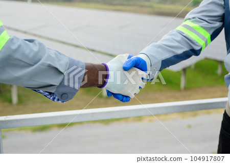 Maintenance engineers working with teamwork at ecological solar farm 104917807