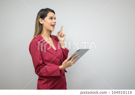 Happy businesswoman working with digital tablet at office Happy businesswoman working with digital tablet at office 104918119