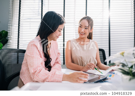 Couple of business people working together at modern office 104918329