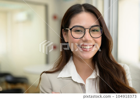 Confident businesswoman working with happiness at office Confident businesswoman working with happiness at office 104918373