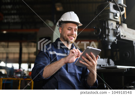 Professional male technician engineer checking machine at factory Professional male technician engineer checking machine at factory 104918548