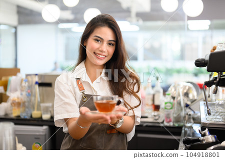 Smiling portrait of young barista business owner at retail coffee shop 104918801