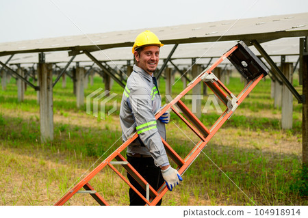 Maintenance technician checking solar panels on solar cell farm Maintenance technician checking solar panels on solar cell farm 104918914