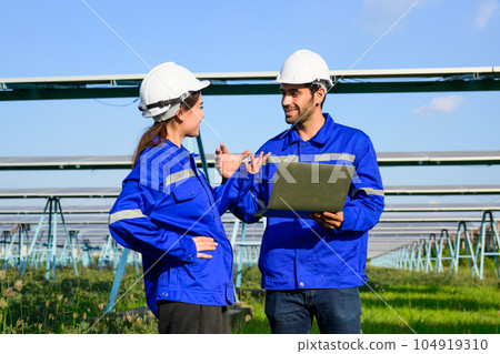 Workers installing solar panels, Engineer team at solar panel farm Workers installing solar panels, Engineer team at solar panel farm 104919310