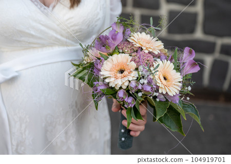 Bride holding Bouquet in female hands. Flowers for the wedding Bride holding Bouquet in female hands. Flowers for the wedding 104919701
