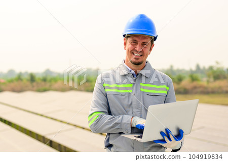Maintenance technician working on ecological solar cell farm 104919834