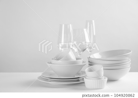 Set of clean dishes on white table 104920862