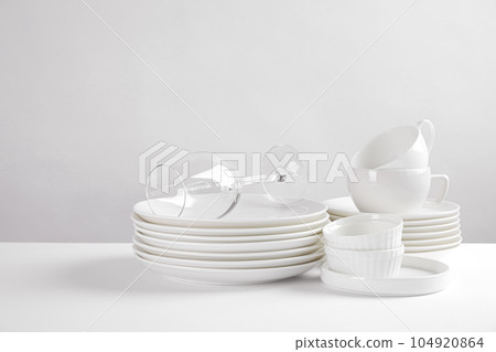 Set of clean dishes on white table 104920864