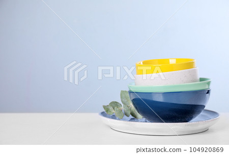 Set of clean tableware on light table. Space for text Set of clean tableware on light table. Space for text 104920869