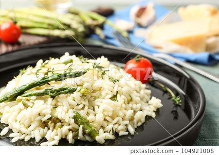 Delicious risotto with asparagus on table, closeup 104921008