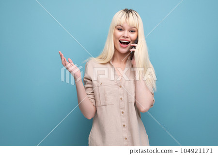 pretty blonde european young lady communicates using smartphone app 104921171