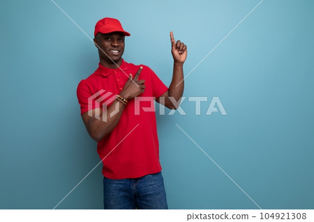 corporate color. handsome african man wearing red t-shirt and cap on background with copy space 104921308