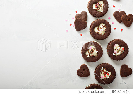 Heart shaped chocolate cookies with cream filling Heart shaped chocolate cookies with cream filling 104921644