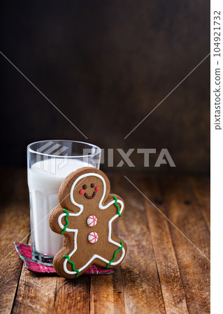 Gingerbread man cookie with a glass of milk 104921732