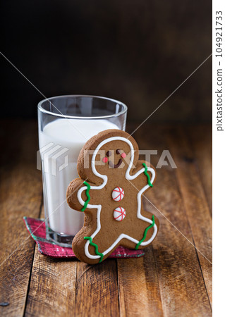 Gingerbread man cookie with a glass of milk 104921733