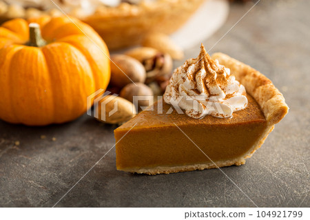 Traditional pumpkin pie with whipped cream 104921799