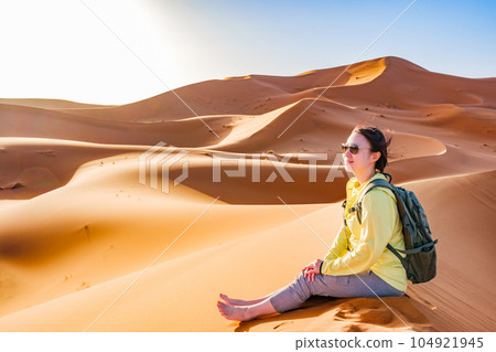 Woman traveling in the Sahara Desert Woman traveling in the Sahara Desert 104921945