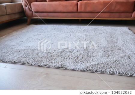 Seamless grey carpet texture background on wooden floor with copy space  104922082