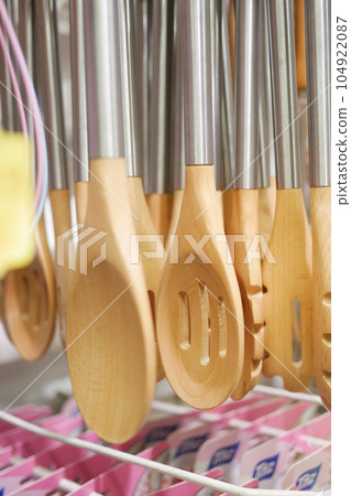 closeup of wooden cutlery forks hanging  104922087