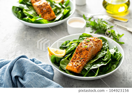Cedar plank roasted salmon with spinach 104923156