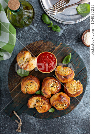 Garlic dinner rolls with marinara sauce 104923235