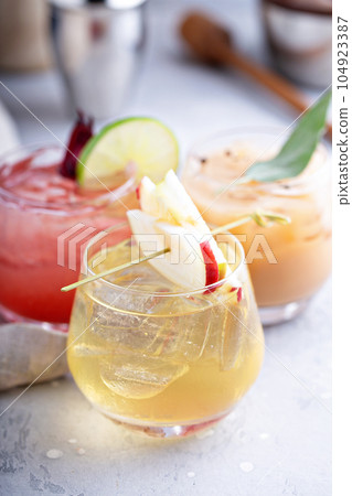 Winter and fall cocktails with apples and oranges 104923387