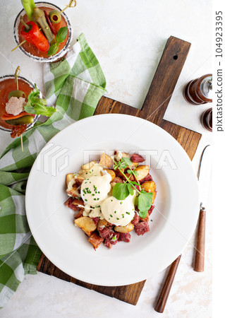 Breakfast potatoes with eggs Benedict and beef Breakfast potatoes with eggs Benedict and beef 104923395