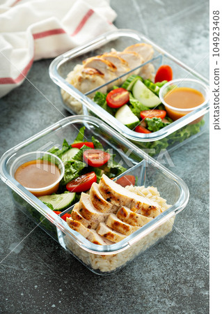 Meal prep containers with grilled chicken 104923408