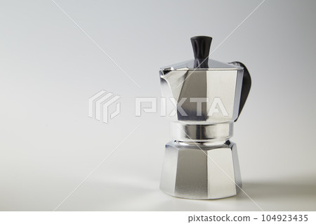 Typical Italian coffee pot or moka in aluminum on white Typical Italian coffee pot or moka in aluminum on white 104923435