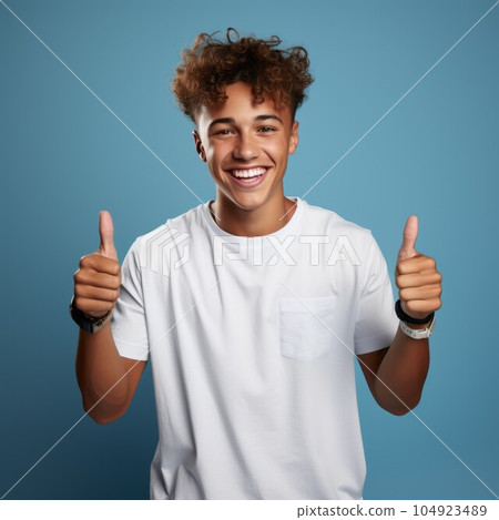 Portrait of a smiling Brazilian teen boy with brown hair. Closeup face of handsome Latin American boy with curly hair smiling at camera on a blue background. Front view, happy teenager in white shirt. Portrait of a smiling Brazilian teen boy with brown hair. Closeup face of handsome Latin American boy with curly hair smiling at camera on a blue background. Front view, happy teenager in white shirt. 104923489