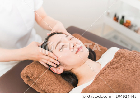 A woman who receives a corgi/bone massage treatment and a woman who is a therapist/esthetician (face) A woman who receives a corgi/bone massage treatment and a woman who is a therapist/esthetician (face) 104924445