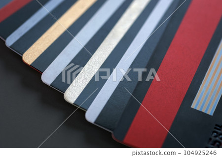Plastic bank cards - credit or debit cards, stacked on black background, closeup Plastic bank cards - credit or debit cards, stacked on black background, closeup 104925246