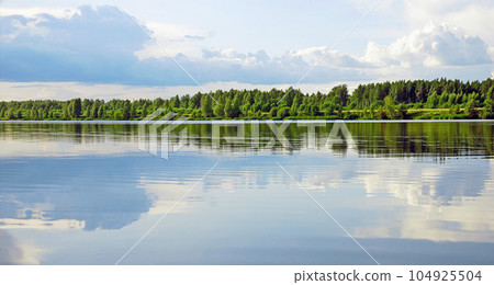 river landscape with blue cloudy sky and green forest 104925504