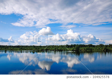 Summer landscape with clouds reflected in river or lake water surface Summer landscape with clouds reflected in river or lake water surface 104925578