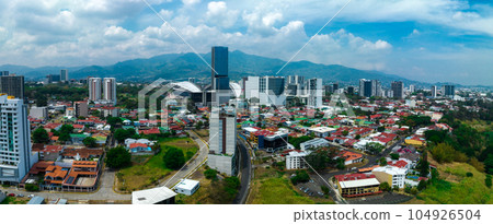 Beautiful aerial view of the Sabana, San Jose, Costa Rica. San Jose Costa rica capital city street view with mountains in the background. Beautiful aerial view of the Sabana, San Jose, Costa Rica. San Jose Costa rica capital city street view with mountains in the background. 104926504