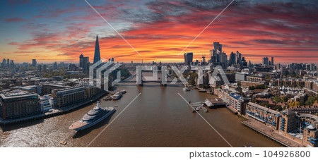 Aerial view of the Tower Bridge in London. One of London's most famous bridges and must-see landmarks in London. Beautiful panorama of London Tower Bridge. Aerial view of the Tower Bridge in London. One of London's most famous bridges and must-see landmarks in London. Beautiful panorama of London Tower Bridge. 104926800