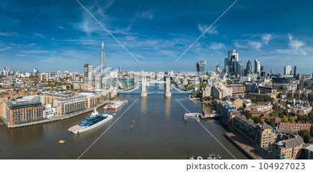 Aerial view of the Tower Bridge in London. One of London's most famous bridges and must-see landmarks in London. Beautiful panorama of London Tower Bridge. Aerial view of the Tower Bridge in London. One of London's most famous bridges and must-see landmarks in London. Beautiful panorama of London Tower Bridge. 104927023