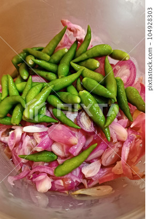 Acar cabe bawang or Chilli and Shallot pickles in plastic container. Acar cabe bawang or Chilli and Shallot pickles in plastic container. 104928303