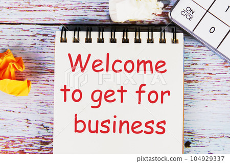 Welcome to get for business on the first page of a notebook on wooden boards Welcome to get for business on the first page of a notebook on wooden boards 104929337