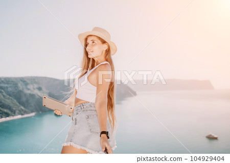 Woman sea laptop. Business woman in yellow hat freelancer with laptop working over blue sea beach. Girl relieves stress from work. Freelance, digital nomad, travel and holidays concept Woman sea laptop. Business woman in yellow hat freelancer with laptop working over blue sea beach. Girl relieves stress from work. Freelance, digital nomad, travel and holidays concept 104929404