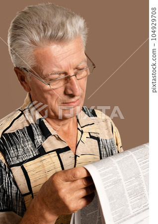 old nice man reading newspaper at home old nice man reading newspaper at home 104929708
